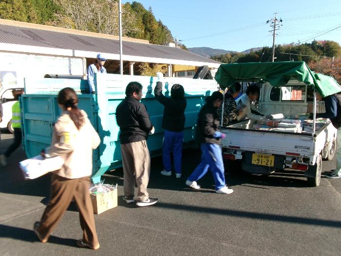 新聞と雑誌を回収する生徒と保護者